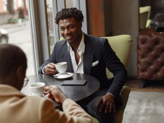 Black men sitting in a cafe drinking coffee