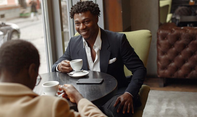 Black men sitting in a cafe drinking coffee